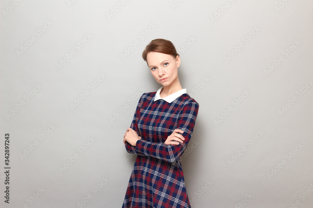 Portrait of serious focused young woman holding arms crossed on chest Portrait of serious focused young woman holding arms crossed on chest