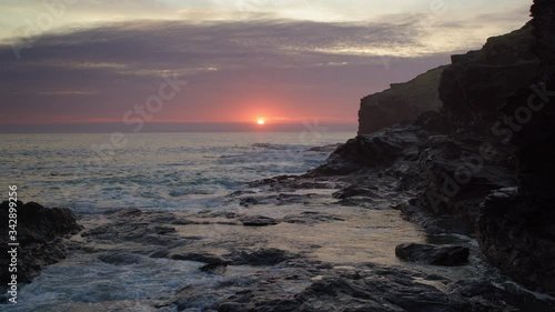 Dramatic Sunset in Cornwall. (Slow moving aerial shot)