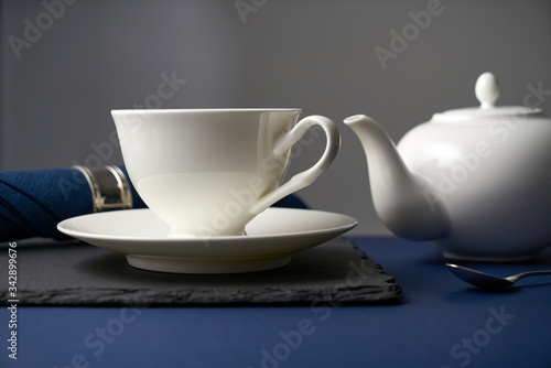 Tea set from a white ceramic teapot and a white cup