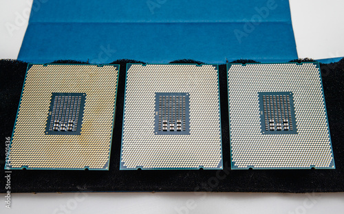 Картината върху платно Above view of three new powerful new professional CPU processor unboxing