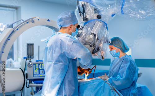 Team surgeon at work in operating room. Modern equipment in operating room. Medical devices for neurosurgery.
