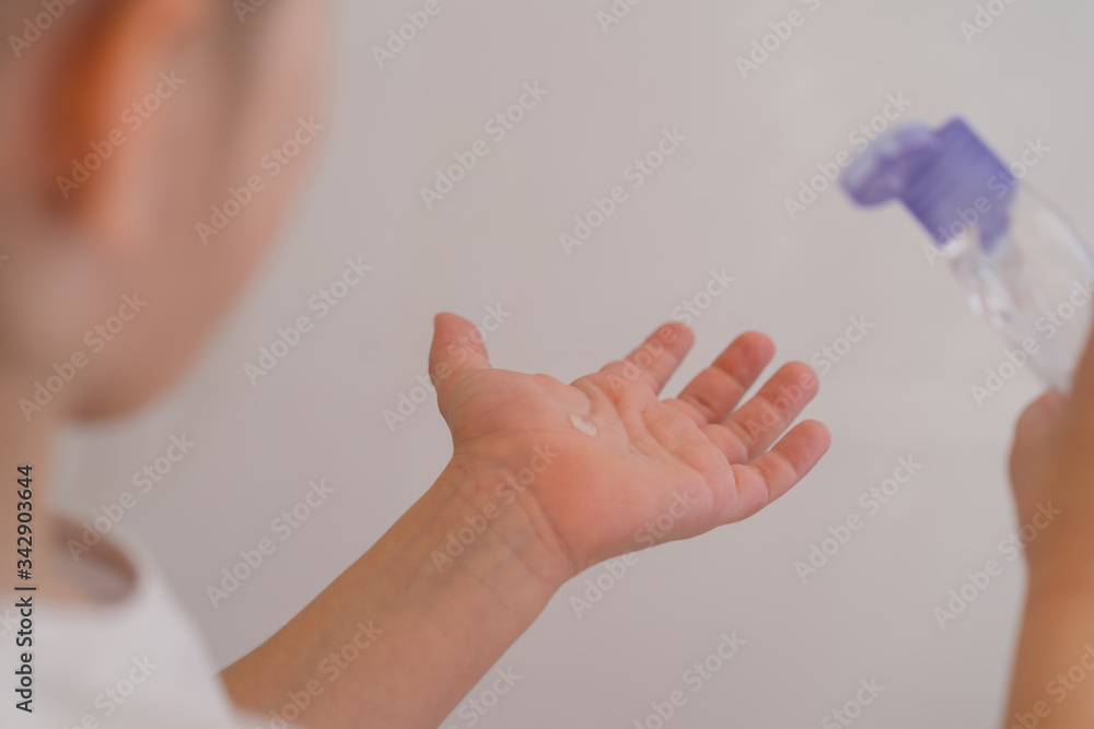 child squeezes liquid soap on hand wash hands, health care, protection from microbes, bacteria, viruses, coronavirus, washing hands concept child squeezes liquid soap on hand wash hands, health care, protection from microbes, bacteria, viruses, coronavirus, washing hands concept