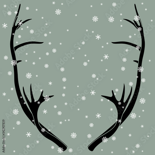 Isolated vector illustration. Winter animal decor. Pair of elk horns under snowflakes. Deer antlers. Symmetrical frame. Monochrome silhouette.
