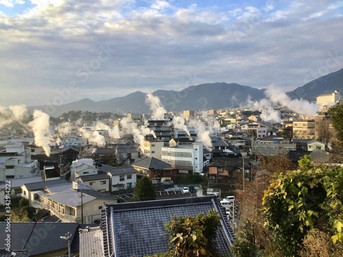 Beppu hot spring town in the morning with rising steam