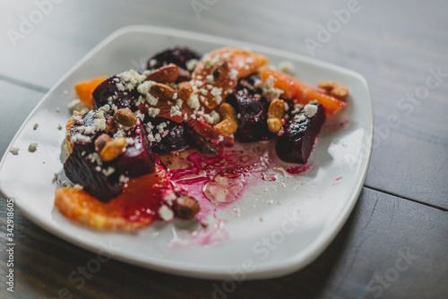 partially eaten plate of roasted beet salad with oranges