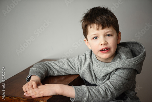 boy in a bike with capbuy silt on a chair