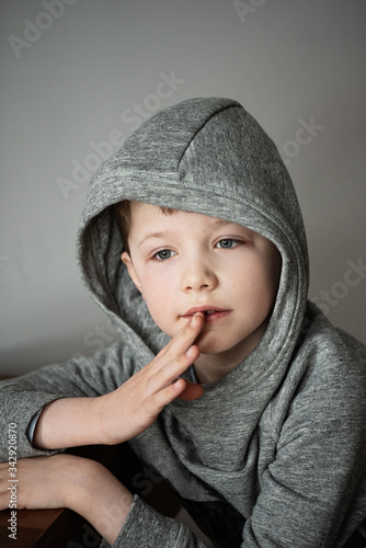 boy in a bike with capbuy silt on a chair