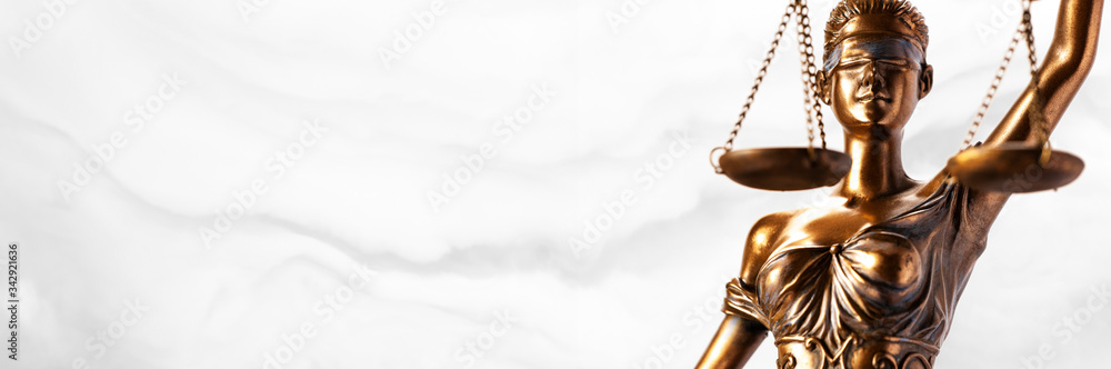 Bronze Themis statue - symbol of Justice - viewed from a low angle with a smoky background Bronze Themis statue - symbol of Justice - viewed from a low angle with a smoky background