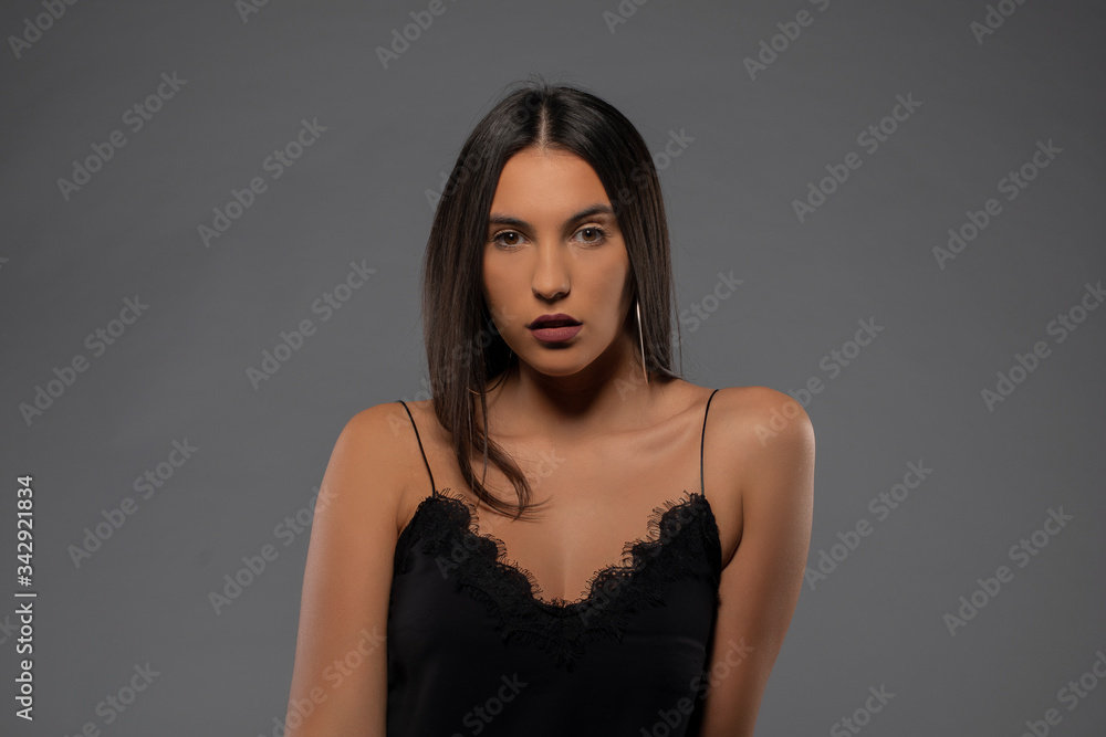Girl posing in studio on grey background. Isolated Girl posing in studio on grey background. Isolated