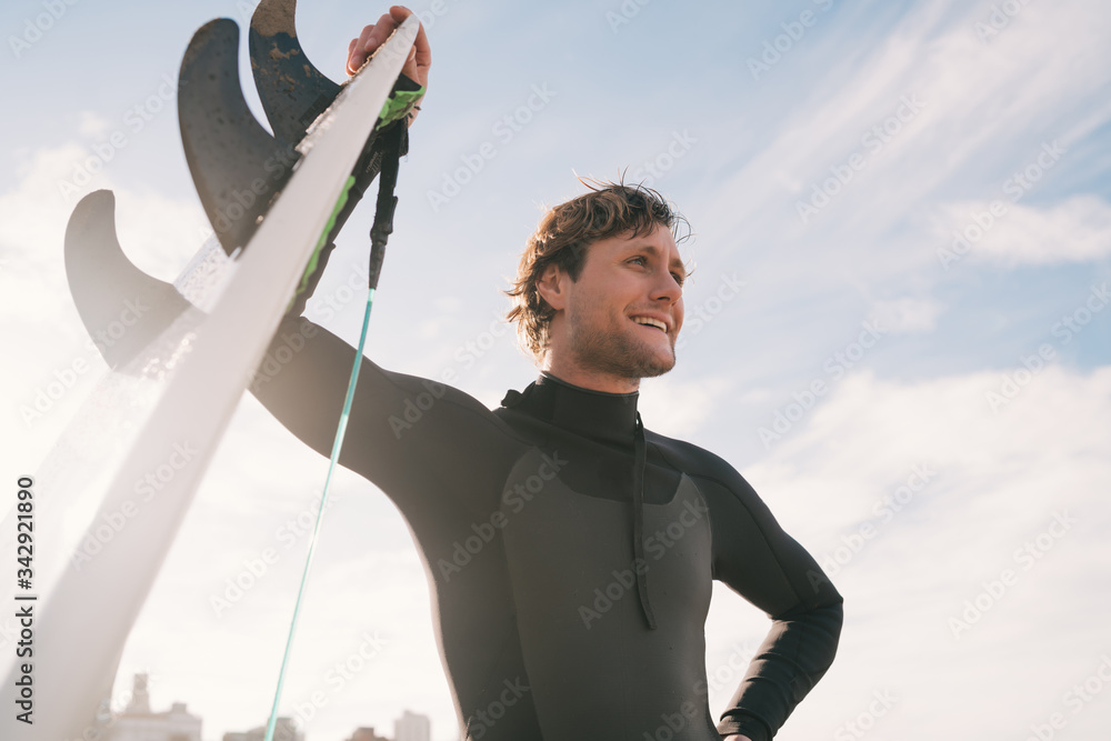 Surfer standing at the beach with surfboard. Surfer standing at the beach with surfboard.