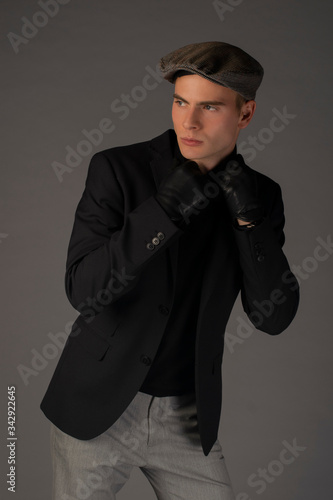 Sexy boy is posing on grey background in studio. Isolated