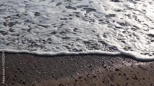 Sea sand beach on which the waves of water come.