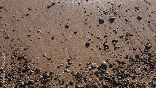 Sea sand beach on which the waves of water come.