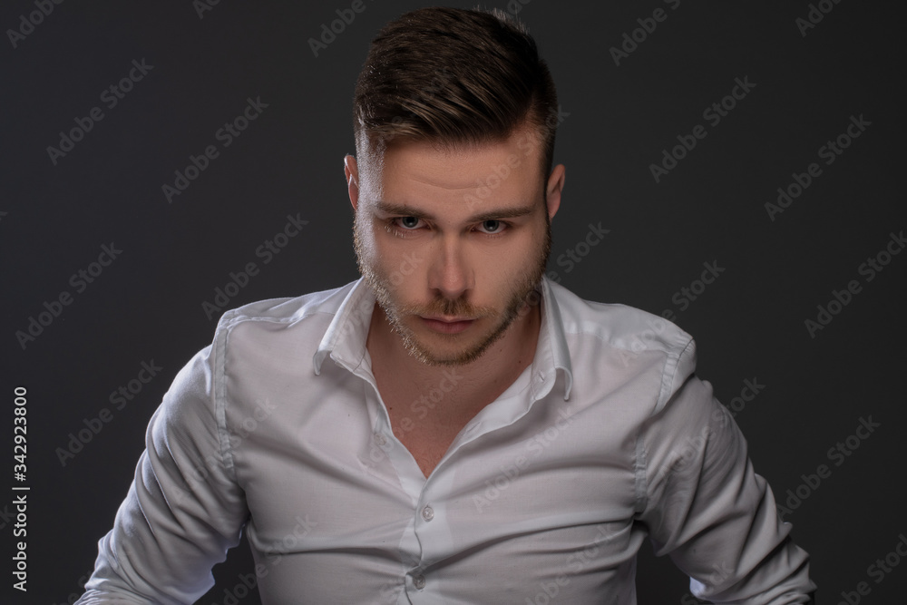 Fototapeta premium Portrait of beautiful man on grey background. Studio Isolated