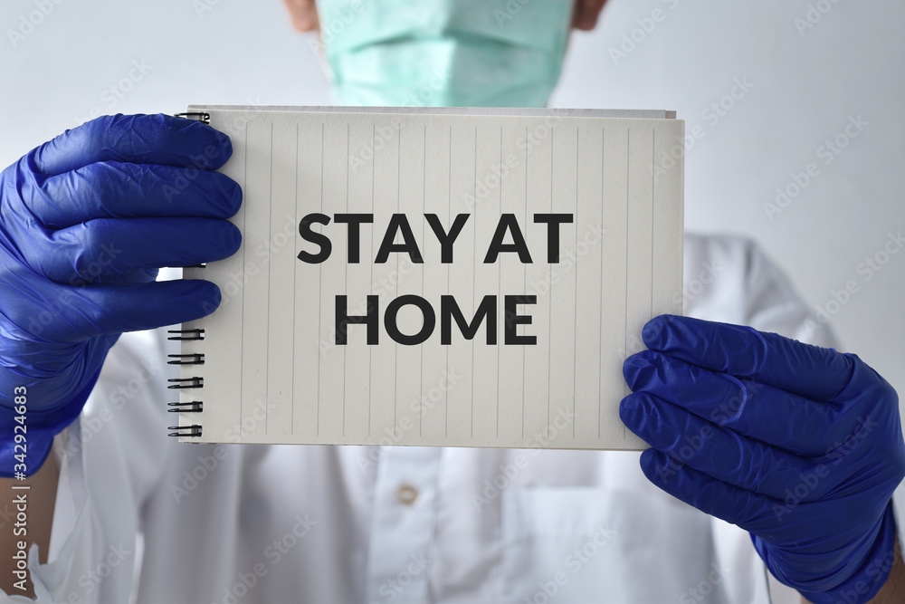 A doctor with a paper with stay at home holding on hand A doctor with a paper with stay at home holding on hand