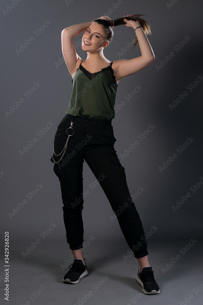 Portrait of girl posing in studio on grey background. Isolated Portrait of girl posing in studio on grey background. Isolated