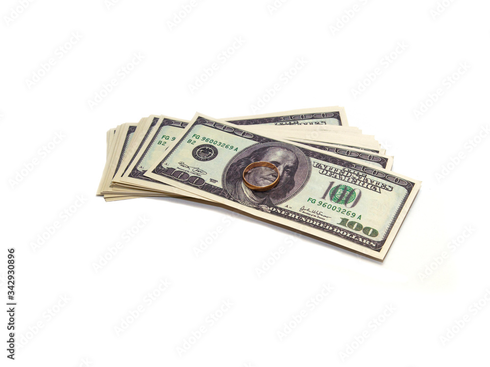 one hundred dollar pack and a golden ring on top one hundred dollar pack and a golden ring on top