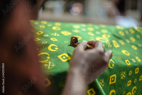 Solo Indonesia, April 27 2020 : Close Up Hand Painting Gold Batik on the Fabric