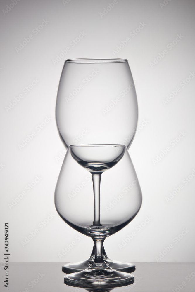 Empty glasses for wine and cognac on gray background. Glassware Empty glasses for wine and cognac on gray background. Glassware