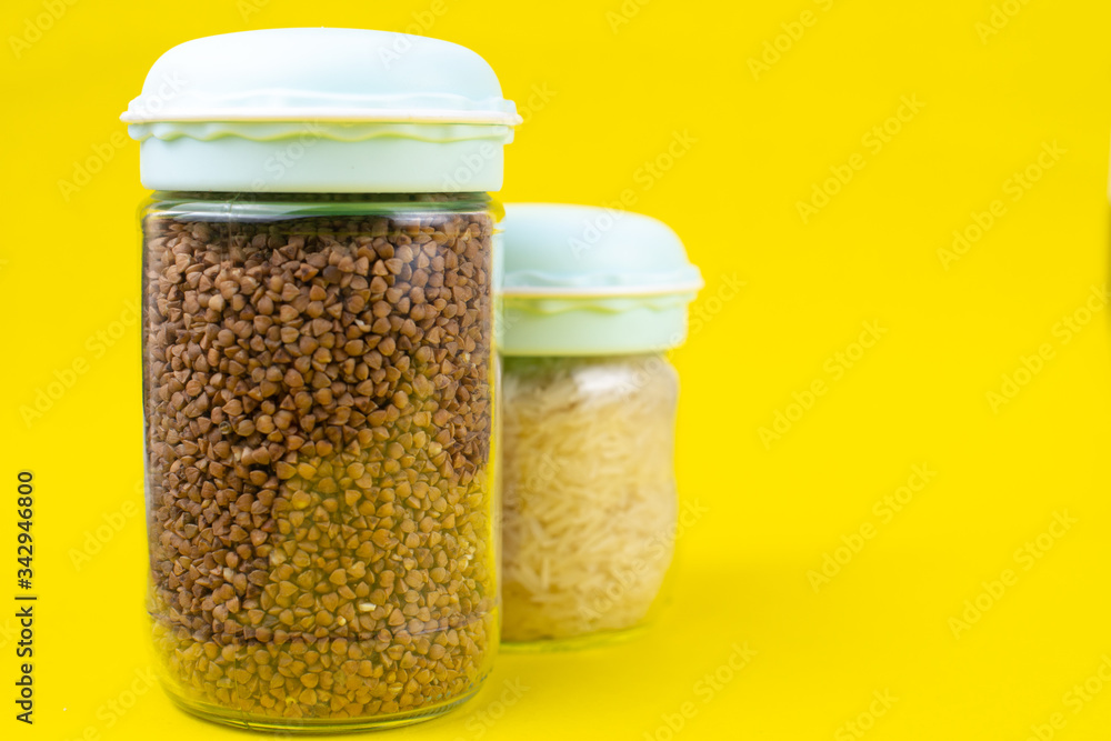 Food stock for quarantine isolation period on yellow background. Rice and buckwheat. Food delivery, Donation. Copyspace Food stock for quarantine isolation period on yellow background. Rice and buckwheat. Food delivery, Donation. Copyspace