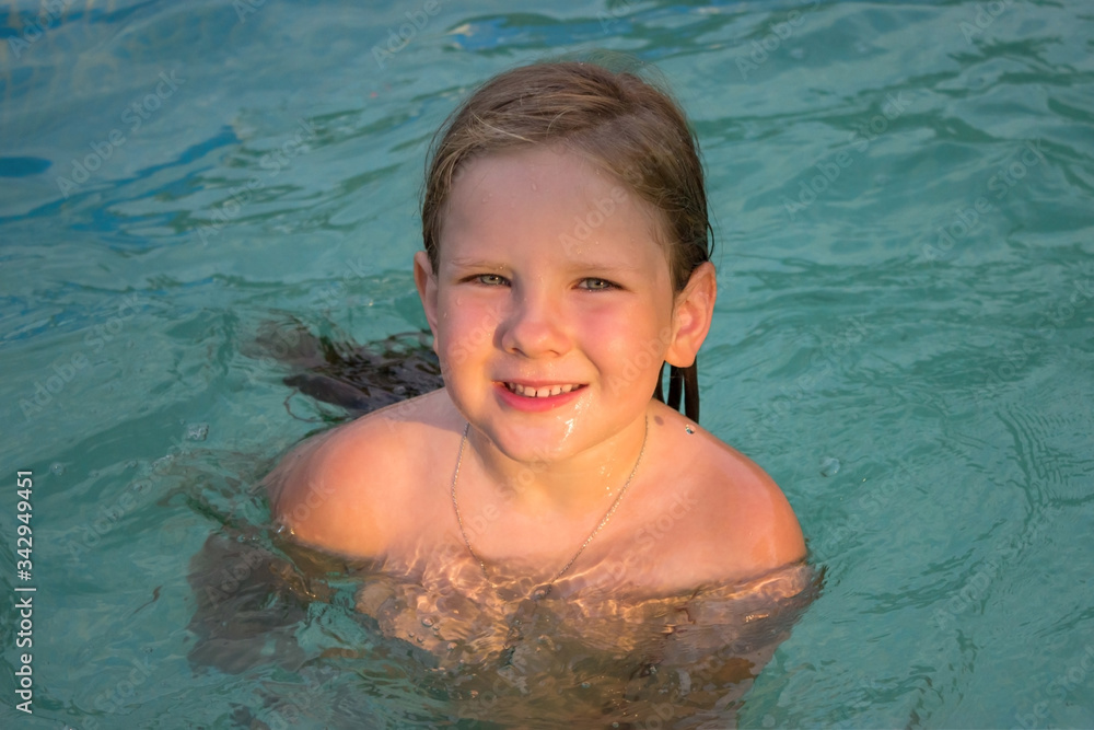 A father has fun with his children in the water in a pre-fabricated frame pool. Family games in the water in the fresh air. A father has fun with his children in the water in a pre-fabricated frame pool. Family games in the water in the fresh air.