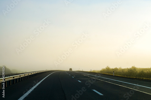 two-lane road, the track goes into fog, the road
