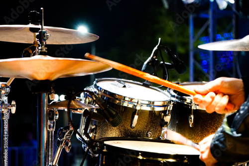 drum set on stage, close-up of the hands of a drummer performing music 
