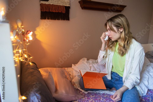 emotional young girl crying and wiping tears with tissue