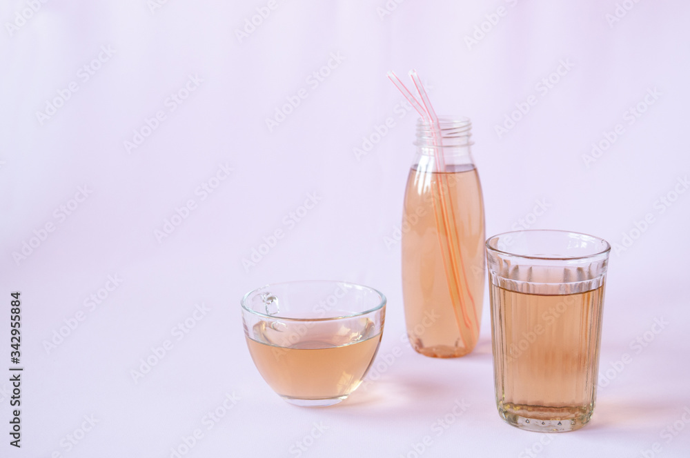 Glassware with Apple juice on a pink background Glassware with Apple juice on a pink background