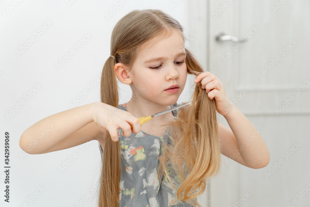 little girl cutting hair to herself with scissors little girl cutting hair to herself with scissors