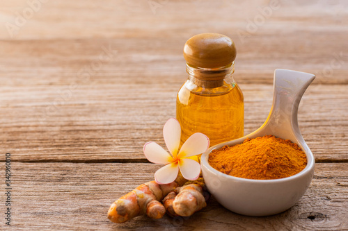 Bild auf Leinwand Turmeric powder ( curcumin, Curcuma longa Linn), glass bottle of honey, tumeric essential oil  isolated on white background