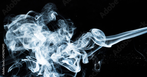 Photo of a wisp of smoke on a dark background photo