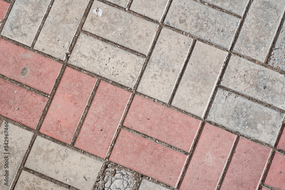 Background image of texture of pedestrian footpath covered by paving tiles