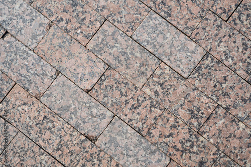 Background image of texture of pedestrian footpath covered with marble tiles