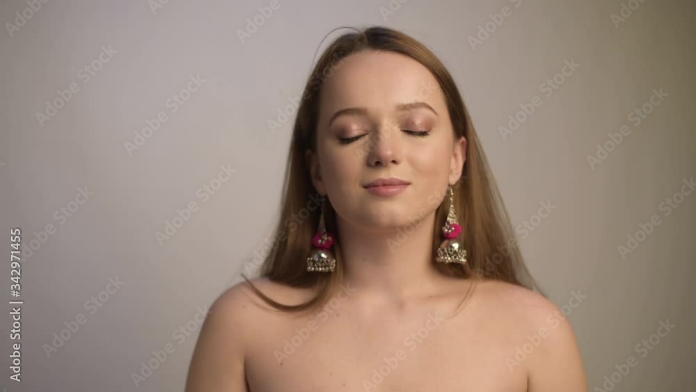 The girl takes off the black mask and breathes in freely. The girl blooms when she takes off her mask and breathes deeply, smiles. Model in the studio on a white background. The girl takes off the black mask and breathes in freely. The girl blooms when she takes off her mask and breathes deeply, smiles. Model in the studio on a white background.