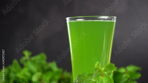 Rotating mixed green vegetables with fruits juice in a glass, Healthy food.