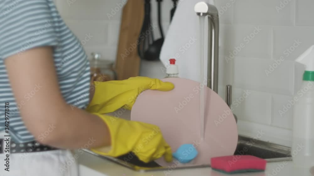 Woman washes a huge fish at kitchen Woman washes a huge fish at kitchen