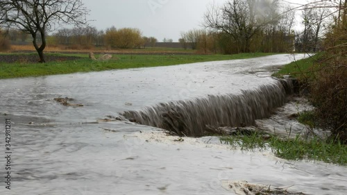 A huge landslide with a flowing dirty big puddle. Natural disaster.