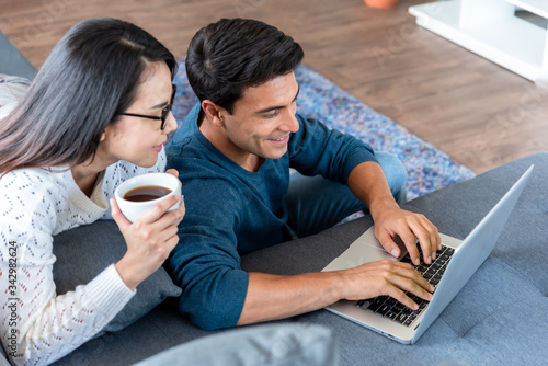 Couple work at home during lock down of corona virus outbreak use laptop connected to internet photo