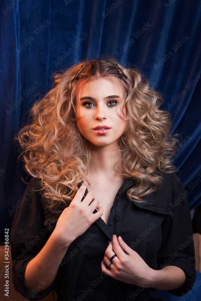 Blonde girl with long and volume shiny wavy hair. Beautiful model woman ...