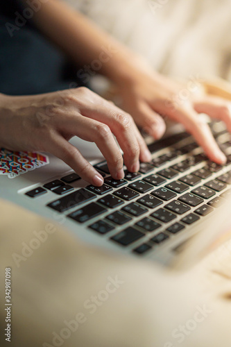 Coronavirus, unrecognized woman typing keyboard on the laptop while working from home  and study online Medium shot