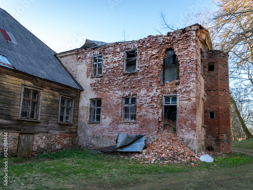 view of the old Augstroze manor, half-ruined side of red bricks, empty windows photo