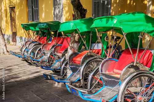 cyclo on a street of Hoi An old town,Quang Nam, Vietnam. photo