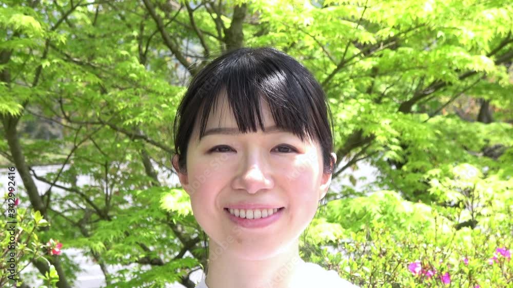 Close up shot of the happy young Asian woman smiling, feeling relaxed. 4K Close up shot of the happy young Asian woman smiling, feeling relaxed. 4K