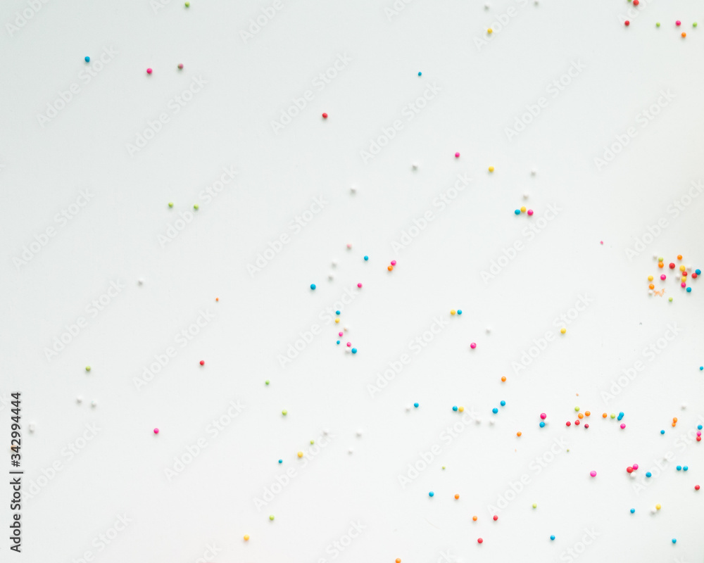 Obraz premium Colourful Sugar sprinkles, decoration for cake, ice-cream and cookies. Top view, Flat lay on white background. Copy space.