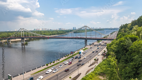 Aerial top view of Kiev city from above, Kyiv skyline, hills, pedestrian Park bridge and Dnieper river cityscape in spring, Ukraine 