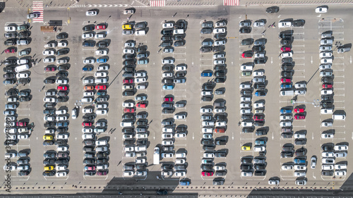 Parking lot with many cars aerial top drone view from above, city transportation and urban concept 