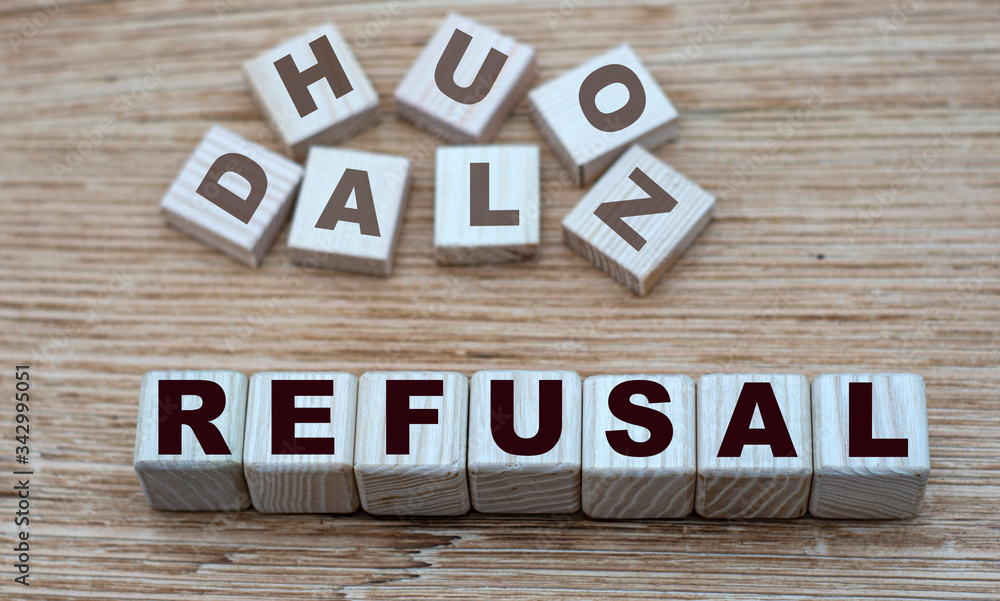 Fototapeta premium concept of the word REFUSAL on cubes on a light wooden background
