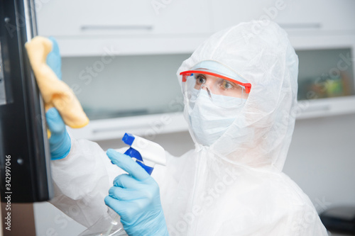 Processing disinfection of apartment premises from virus coronavirus and bacteria, cleaning company cleans TV