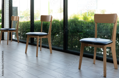 picture of chairs in the restaurant that was placed spreadly due to social distancing or isolation during covid-19 or coronavirus pandemic to prevent infection. new normal lifestyle concept